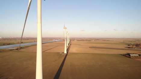 Slow-motion-aerial-view-of-wind-turbines-in-a-field