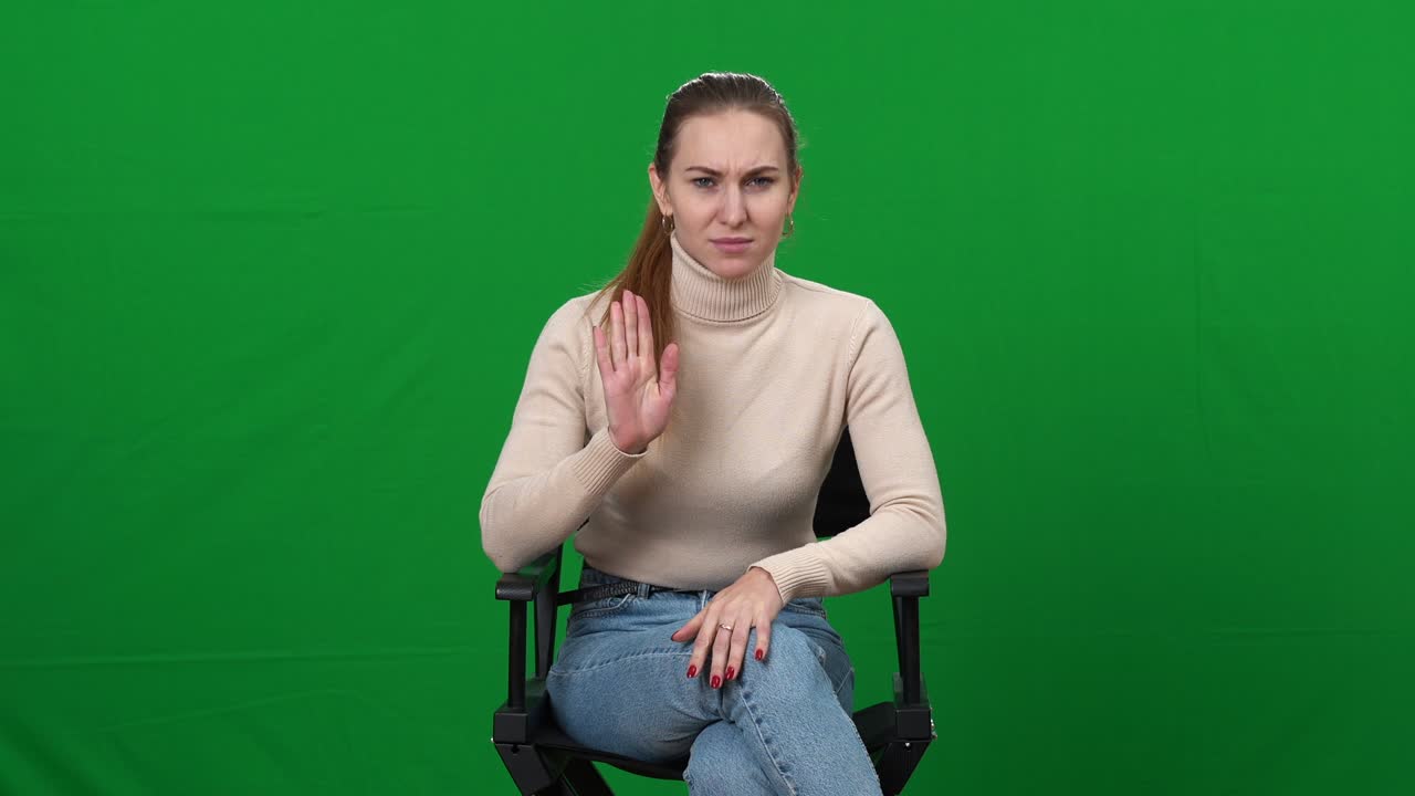 Professional young woman interviewing applicant actor, waving goodbye and making facepalm gesture. Portrait of Caucasian casting director shocked with skills of artist. Green screen