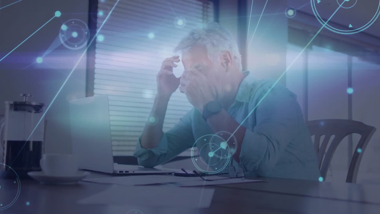 Remote IT manager receiving network alert and analyzing node overlay on laptop while fixing issue