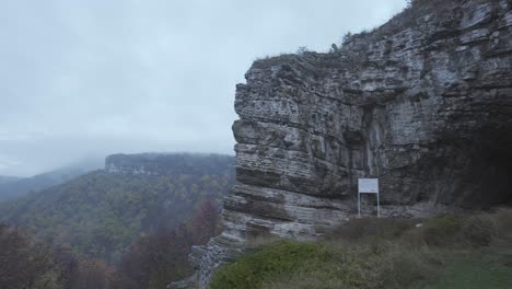 Panning-from-the-right-to-the-left-side-of-the-frame-at-the-entrance-of-Kozarnika-Cave,-located-in-the-Balkan-Mountain-range,-in-the-municipality-of-Dimovo-in-Bulgaria