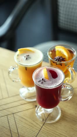 three glasses of warm spiced drinks