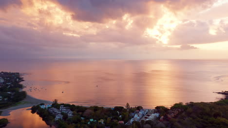 Aerial-Drone-Shot-of-Amazing-Sunset-with-Orange-Pinkish-Sky-Reflecting-on-the-Ocean