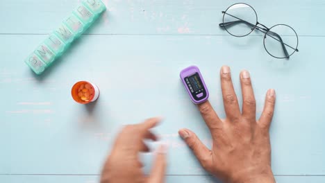 taking medication and using a pulse oximeter