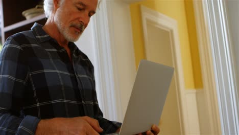Senior-man-using-laptop-at-home-4k