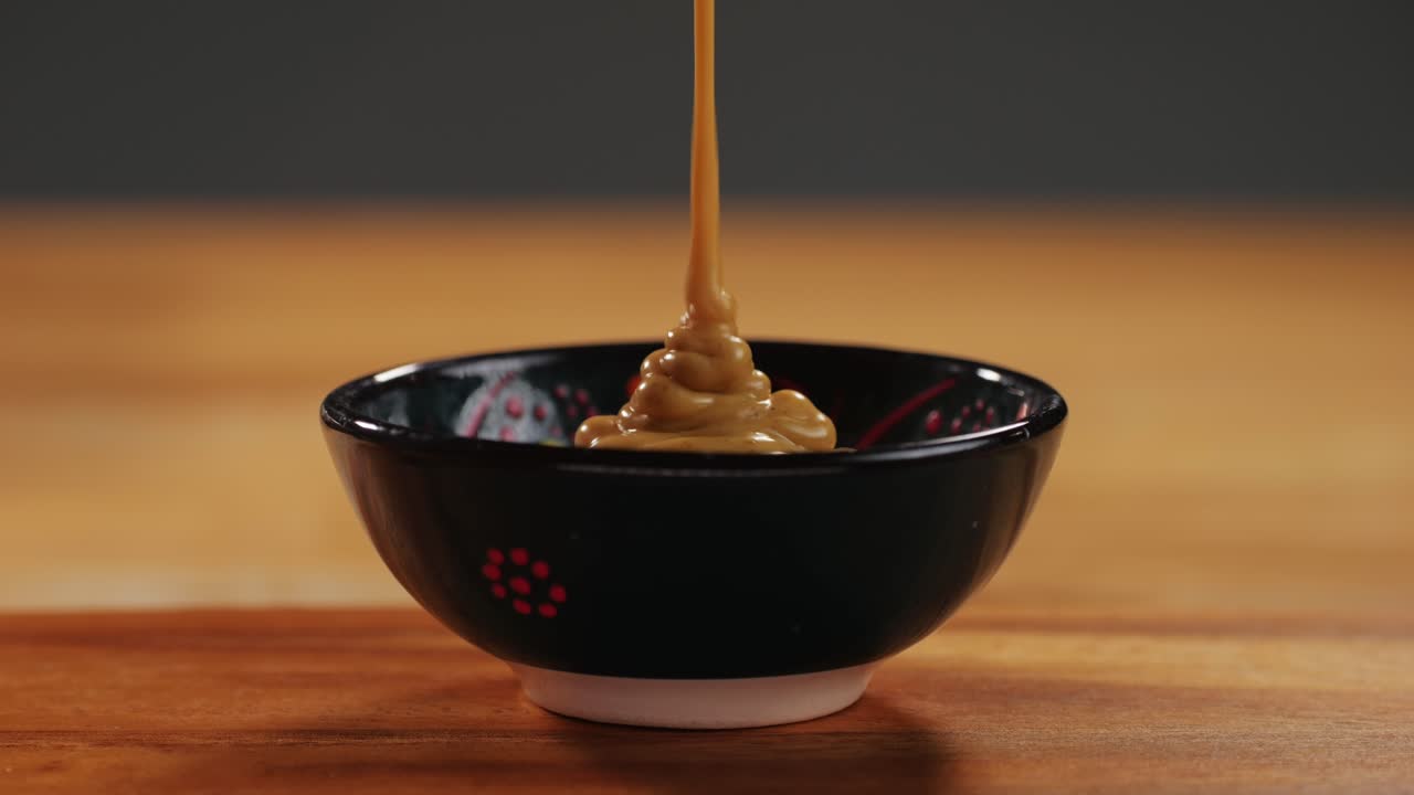 Indian yellow curry sauce for fish and meat close-up. Spicy sauce for many various dishes. Meat or vegetables, oil or ghee, spices. Mustard. High quality 4k footage
