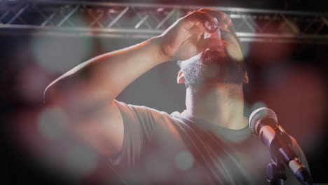 Man drinking shot on stage, with animated lens flare graphics boosting technology theme