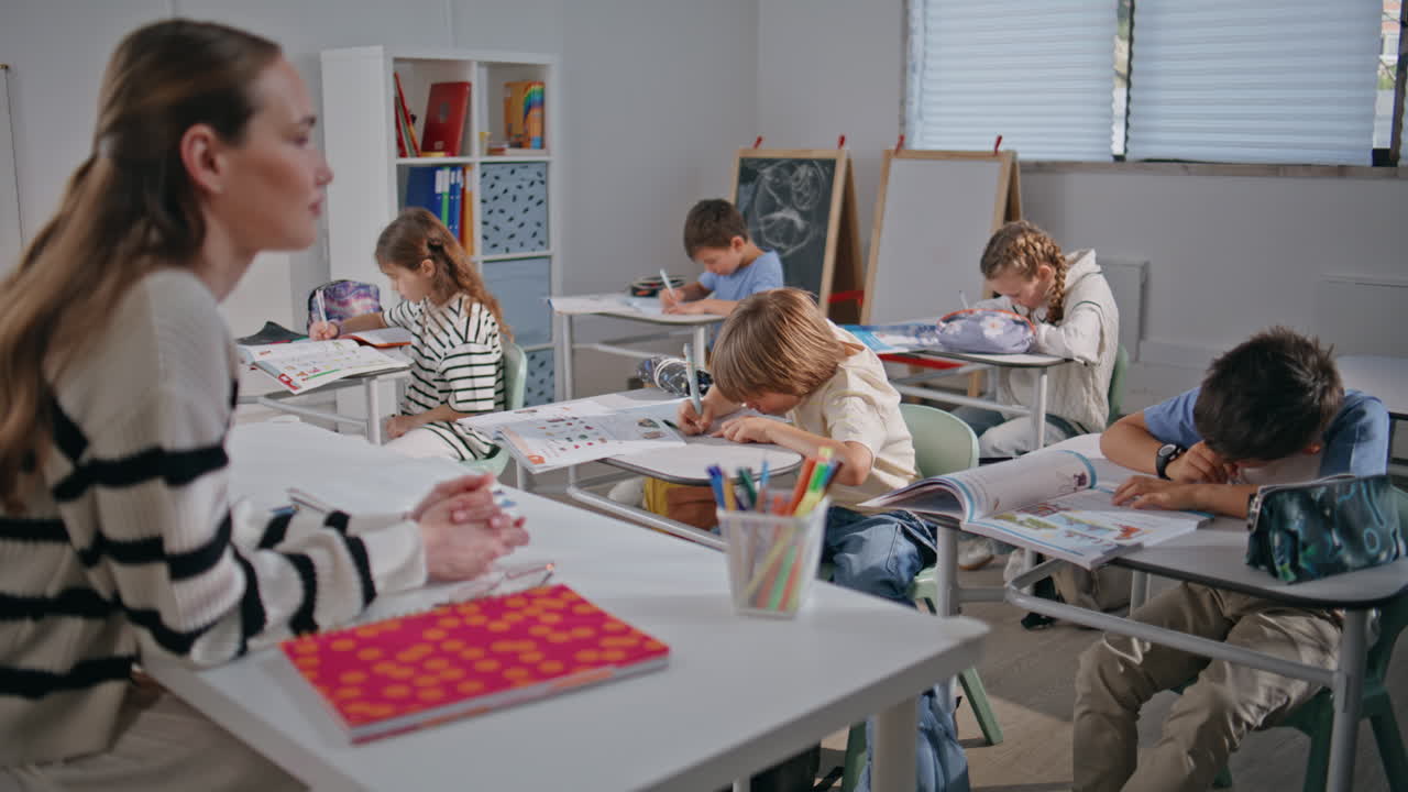 Teacher asking questions lesson closeup. Group pupils learning school classroom