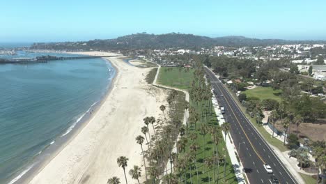 High-altitude-aerial-over-public-beach-and-state-park-on-the-beach-overseeing-Sterns-Wharf-in-Santa-Barbara,-California,-USA