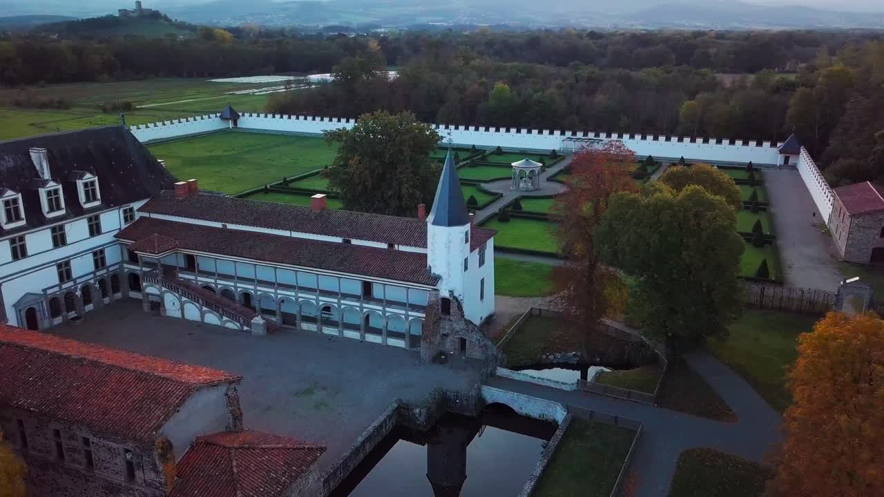aerial shot over the Batie d'Urfe Castle during fall in Saint Etienne le Molard within the province of Forez in Loire departement, Rhone Alpes region, France