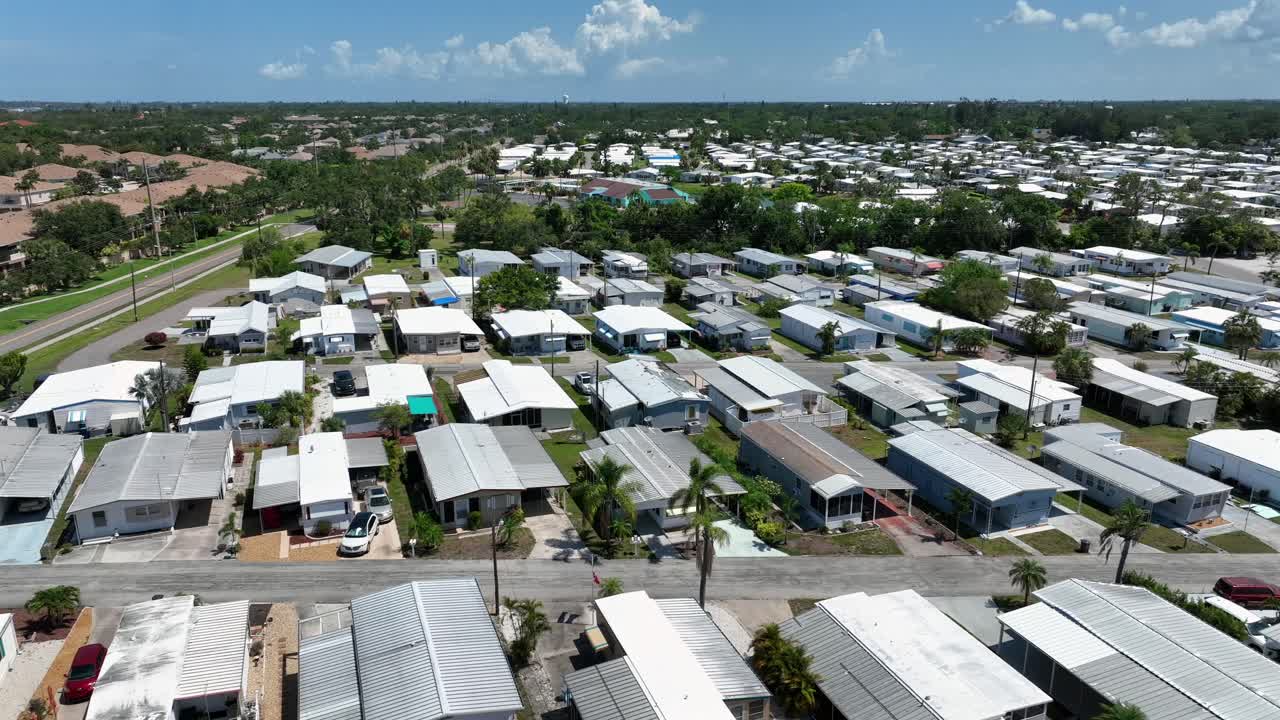 Mobile Houses and homes community in Cortez, Florida. Sunny day in America . Aerial wide shot. Dense crowded residential neighborhood along palm trees street.