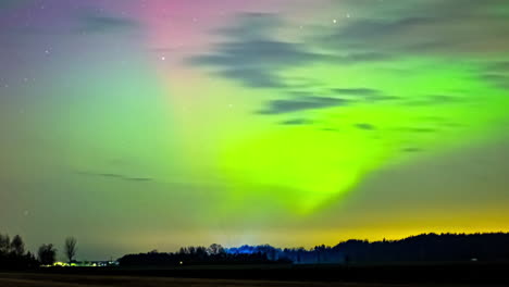 northern lights show in multiple colors across latvia countryside, aurora shimmer throughout the sky