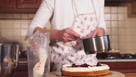 woman decorating a delicious cake with cherry topping