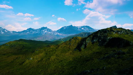 mountain gorge with green meadow illuminated by the sun