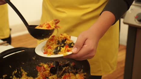 slowmo - chef preparing prawns, shrimps, mussels, rice and tomatoes traditional asian dish