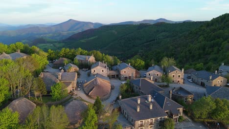 Aerial forward motion from O Cebreiro village toward the mountains of Galicia. Evokes the start of a spiritual journey along the Camino de Santiago. Natural, cultural and emotional setting.