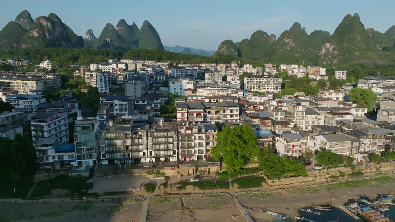 Aerial tracking shot in front suburbs of Yangshuo, summer evening in China