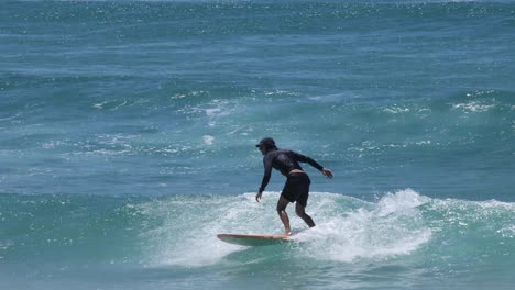 sequence of a surfer catching and riding a wave