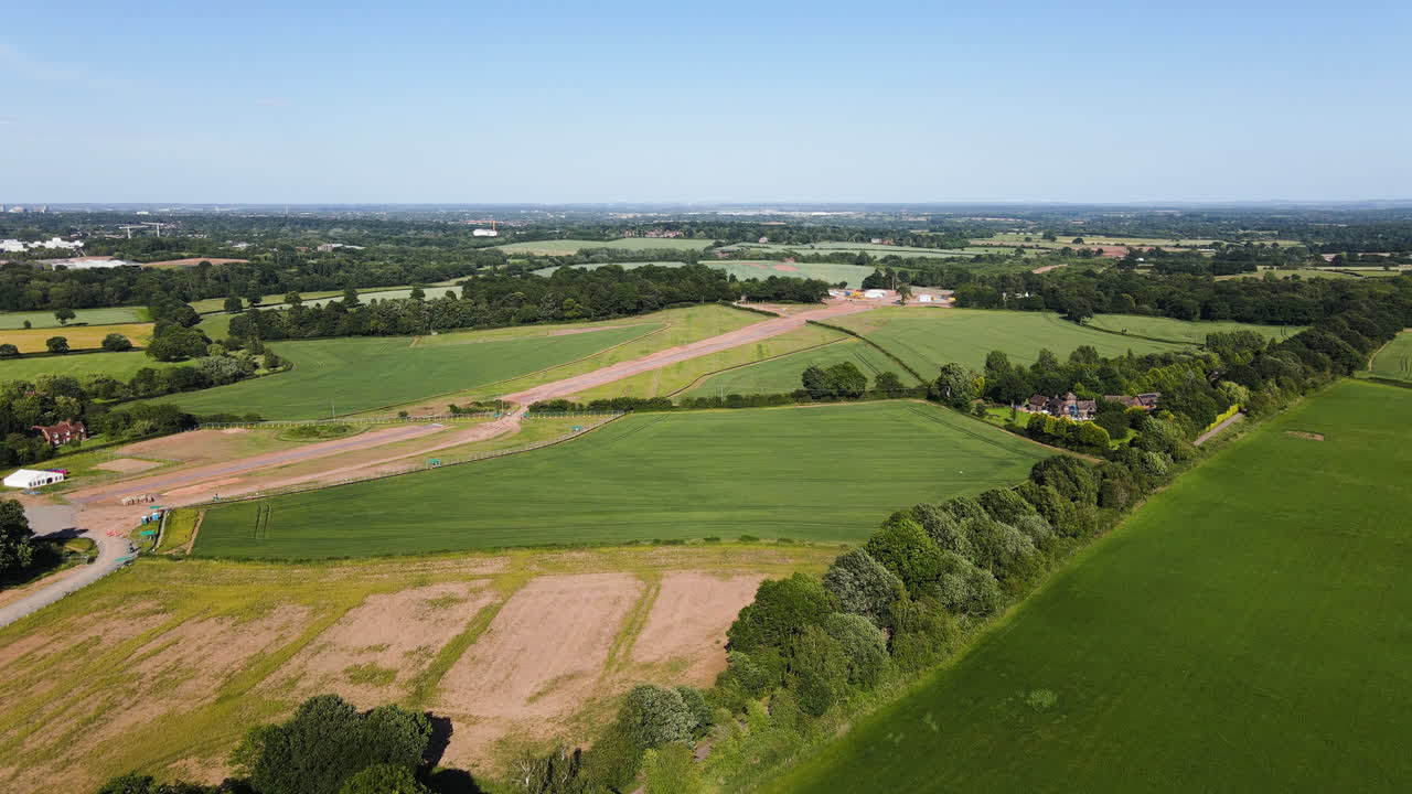 Landscape of beautiful English green and pleasant countryside with trees and fields on sunny day