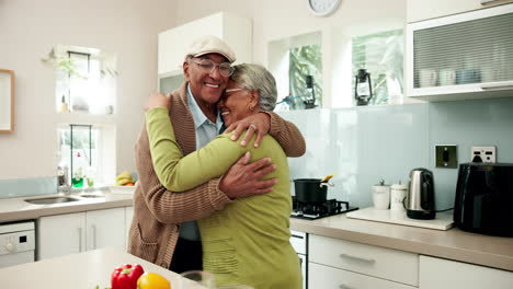 elderly couple embracing in their kitchen