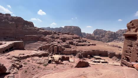 Petra-valley-in-Wadi-Musa,-Jordan-with-The-Treasury-in-the-middle-of-a-rocky-and-mountainous-landscape,-an-UNESCO-heritage-site,-ancient-Nabatean-Kingdom-4K-Establish-Shot