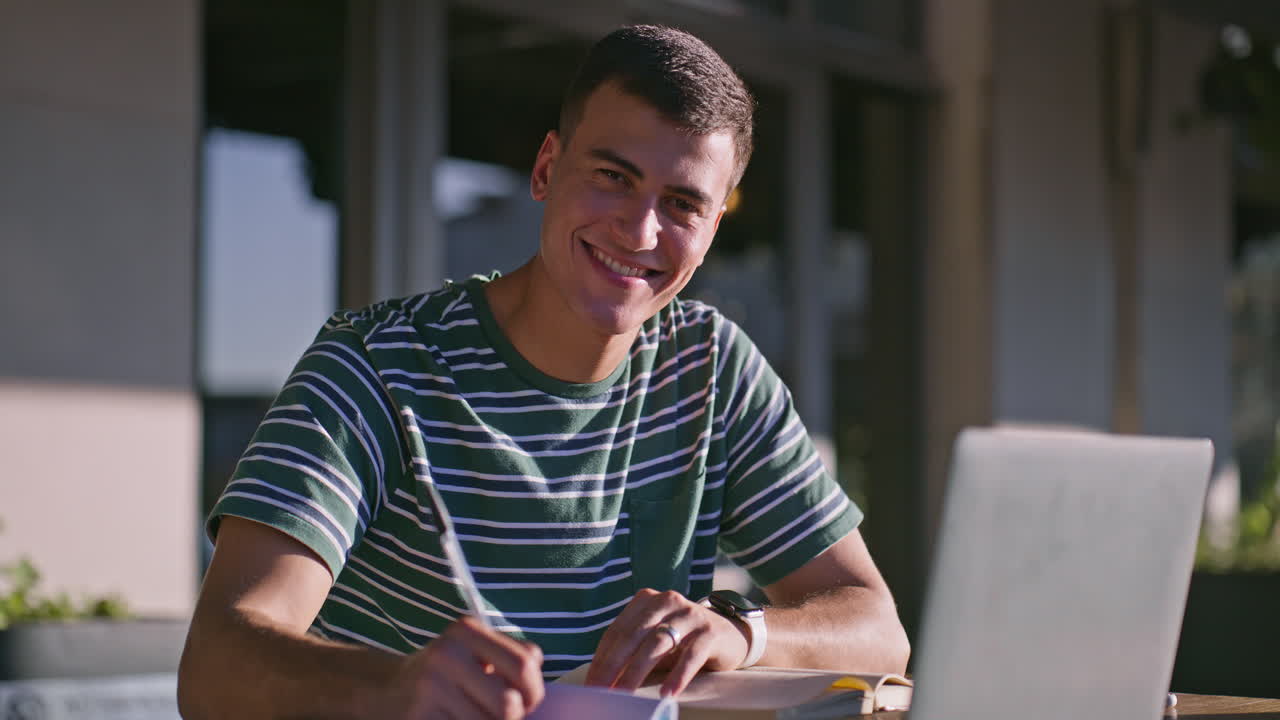 Man studying with laptop and notebook