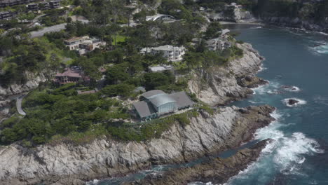 4k drone shot of homes and pristine cove off of the pacific coast highway in the carmel highlands california