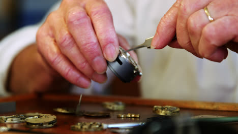 close-up of horologist repairing a watch