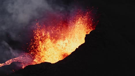steady shot of lava bubbling inside the crater, volcano eruption in iceland - aerial 4k