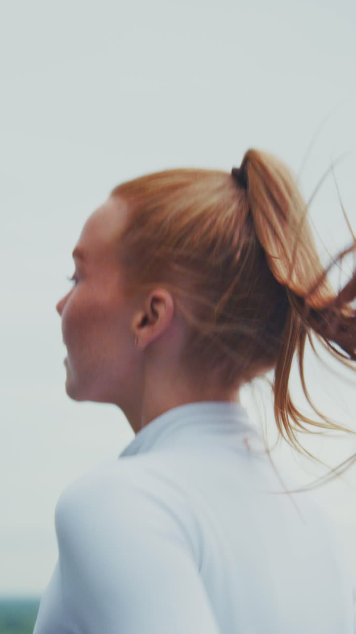 A young woman engages in a morning jog, showcasing a blend of determination and fitness in a serene outdoor setting, exuding a sense of vitality and purpose