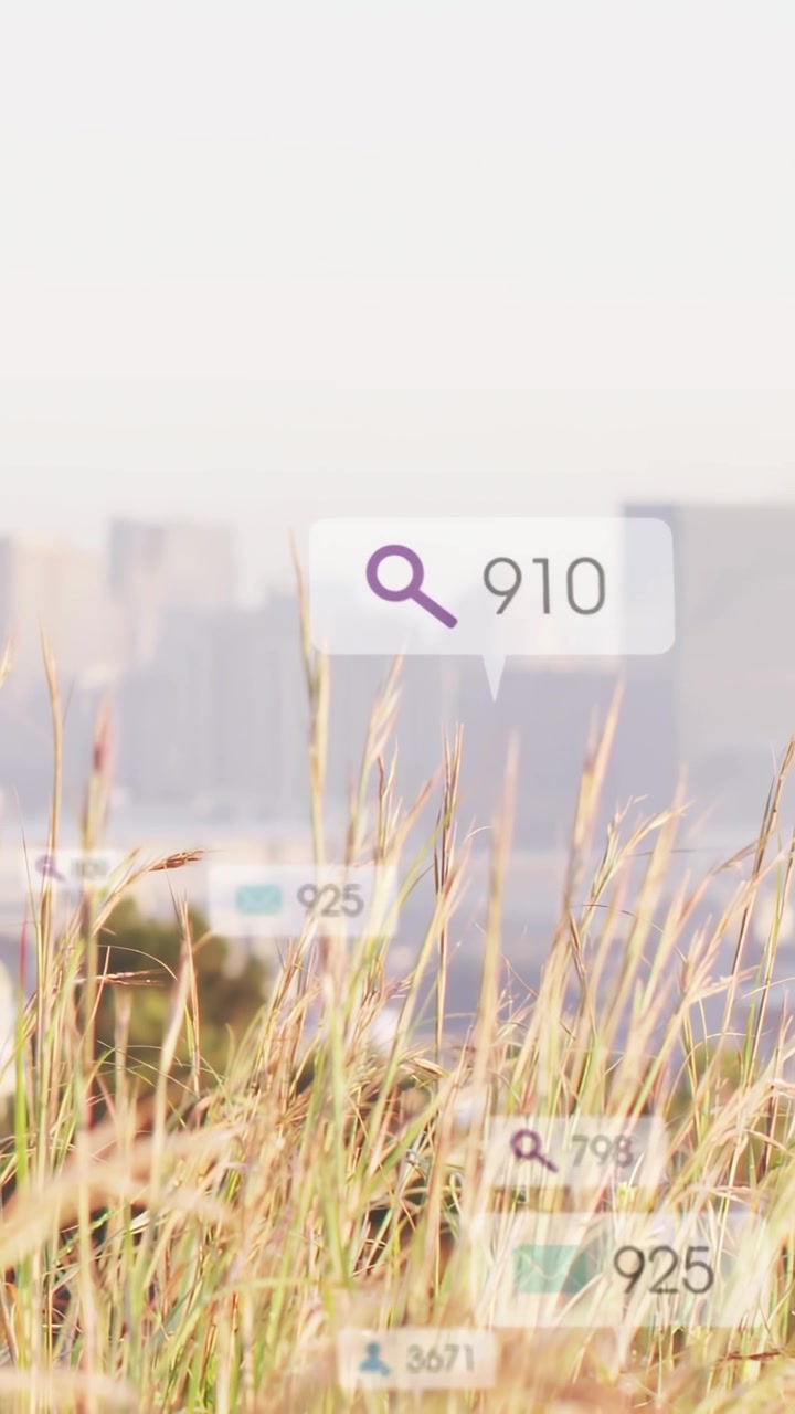 Vertical video: Tall dry grass framing skyline, on overlay soft data bubbles rising showing counts