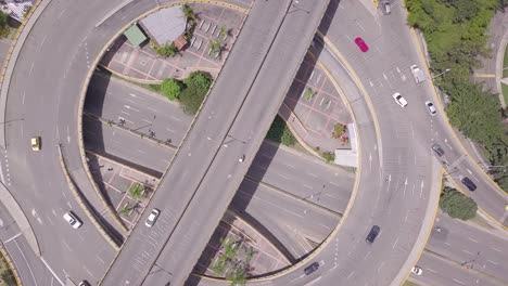 Beautiful-rotating-aerial-4k-shot-of-roundabout-and-traffic-in-summer-day