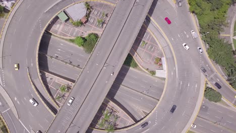 beautiful rotating aerial 4k shot of roundabout and traffic in summer day