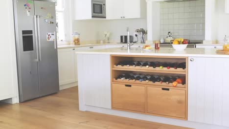 animation of social distancing message under blue roof over an empty kitchen