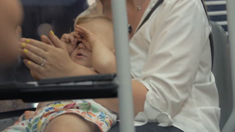 mother with sleepy baby on the bus