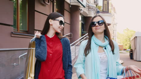 steadicam shot two friends with shopping bags walking in the city