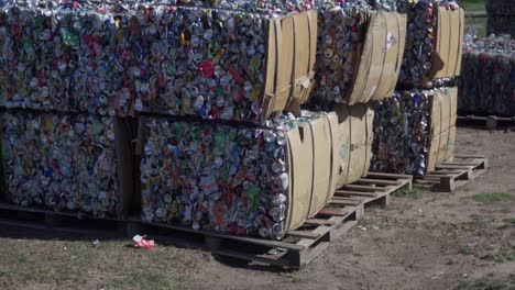 dolly out of a group of bales of compacted waste outside a waste processing facility