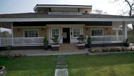 Moving-Towards-A-Beautiful-Bungalow-House-With-Wide-Lawn---dolly-shot