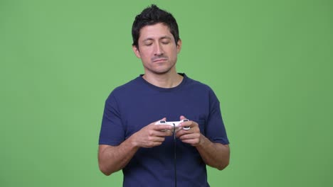 hispanic man playing games and falling asleep