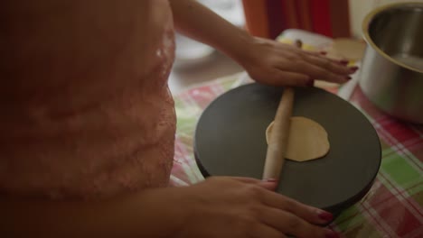 woman hand rolling dough into roti, rotli, chapati, safati, shabaati, phulka, chapo, roshi, india, rolling pin into balls flat bread cultural food ethnic bread