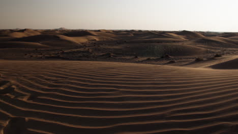Slow-motion-sand-blowing-across-a-desert