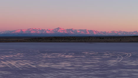 Stunning pink sunset over salt flats of Diamante and Andes mountains in Mendoza, Argentina