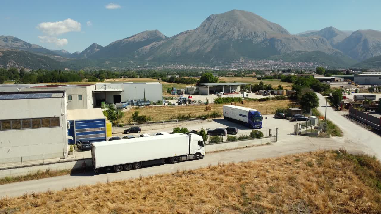 Truck and industrial area view with mountain backdrop