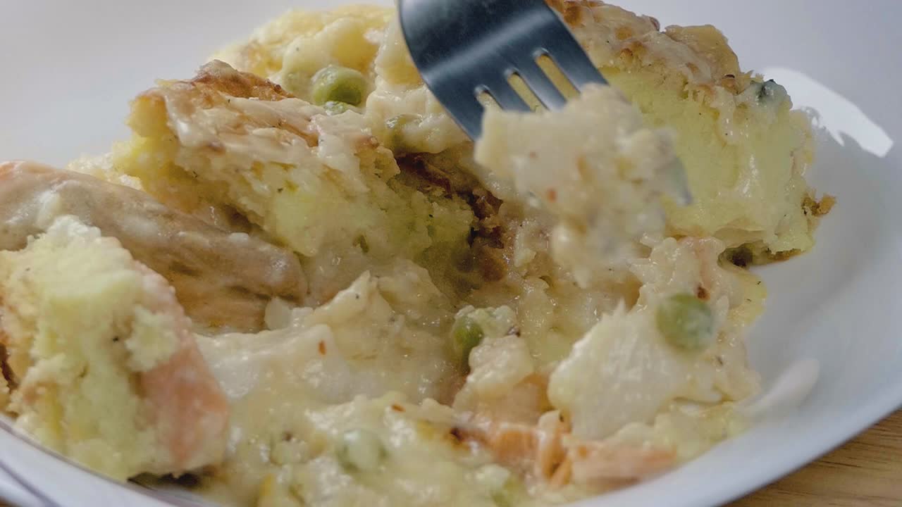 그릇에서 생선 파이를 먹는 슬로우 모션 샷을 닫습니다.