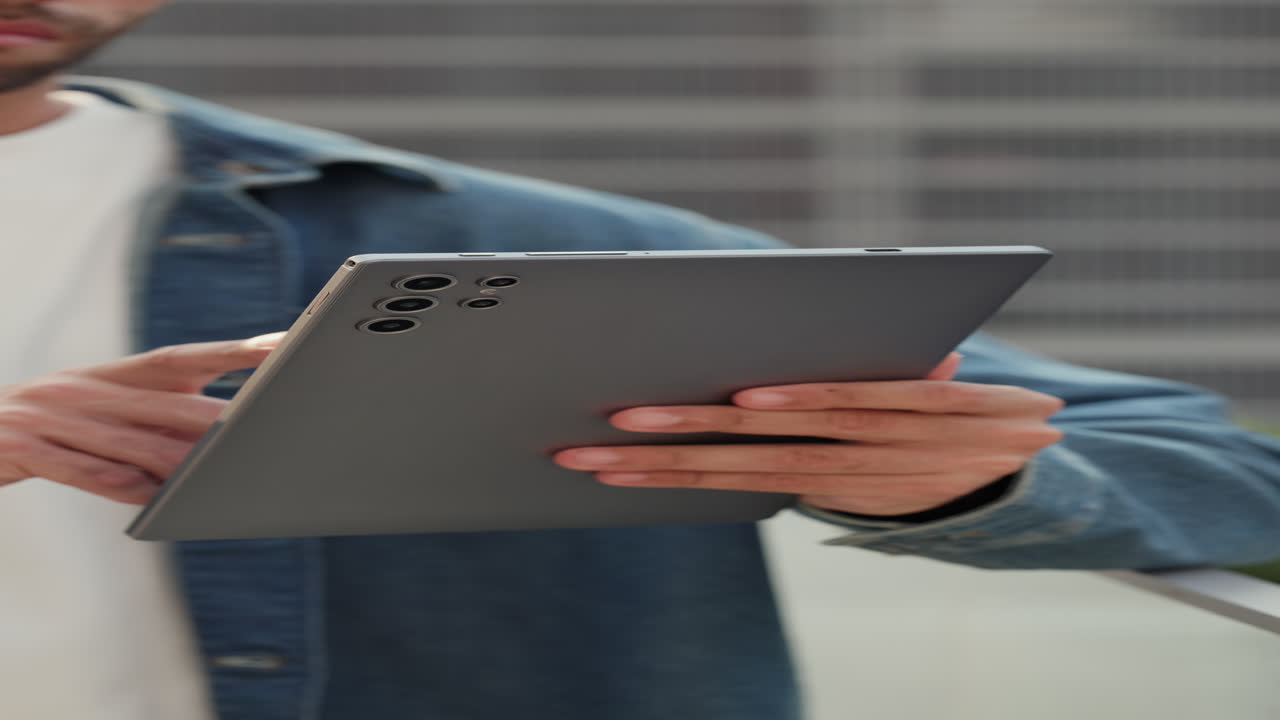 Close-up of Person's Hands Using a Digital Tablet