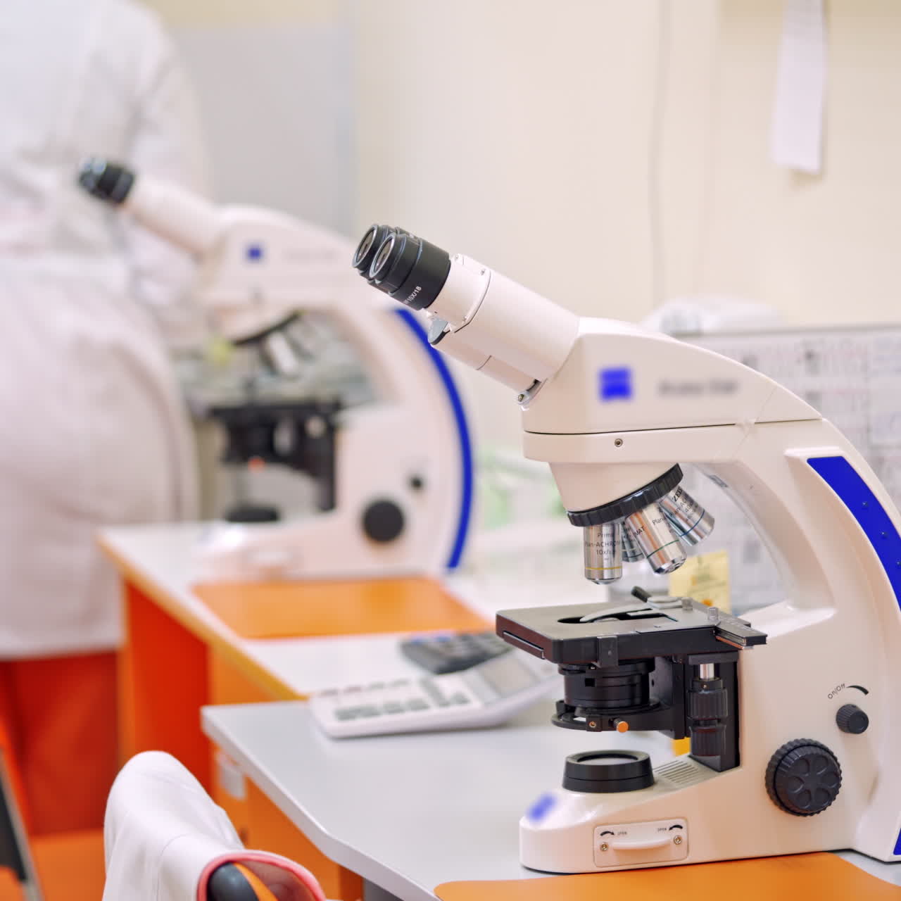 Modern microscope on the table. Laboratory background with contemporary microscopes for scientific researches. Close-up.
