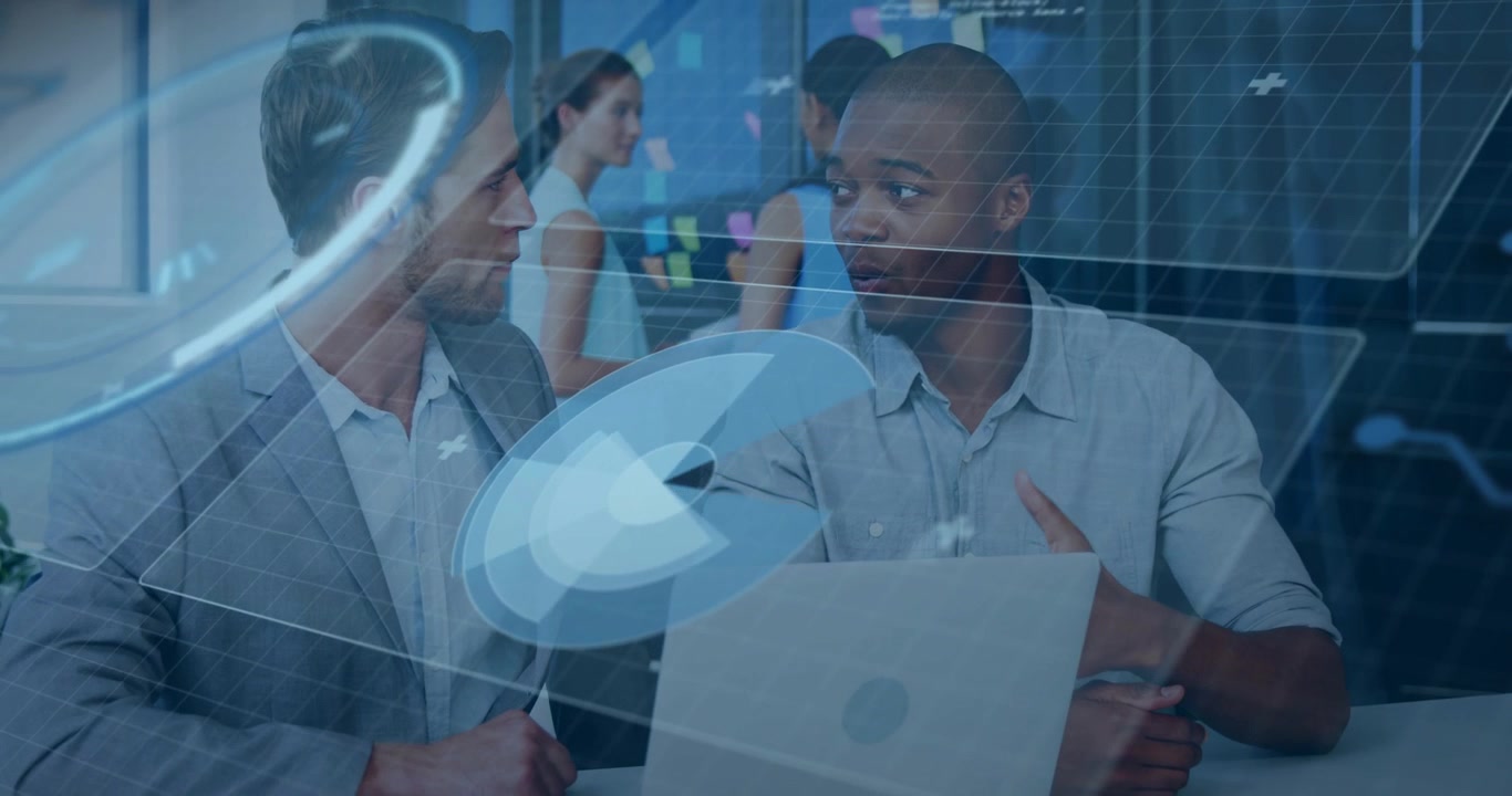 Hologram UI appearing over laptop, two men leaning and reviewing tech visuals near sticky notes