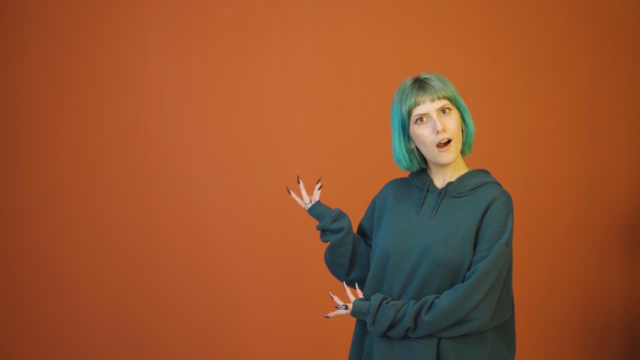 The young woman promoting is looking at the camera in surprise.