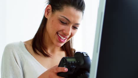 Photographer-looking-at-photos-on-digital-camera