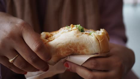 a woman holding a sandwich