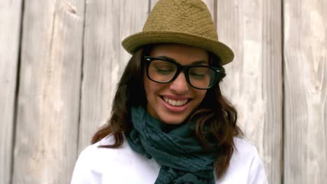 Hipster-reading-against-wooden-fence